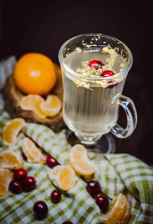 Hot beverage, camomile tea with oranges and cherry