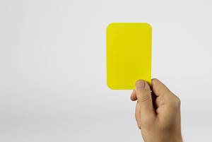 Human hand lifting a yellow card with white background