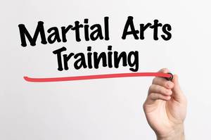 Human hand writing Martial Arts Training on whiteboard