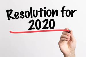 Human hand writing Resolution for 2020 on whiteboard