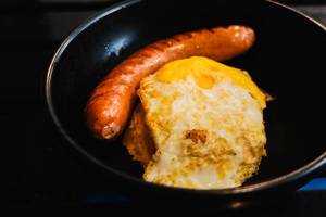 Hungarian sausage with egg in a black bowl