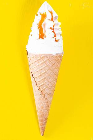 Ice cream cone on a yellow background. Top view