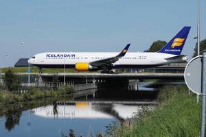 Icelandair plane taxiing on the bridge at Amsterdam Airport, bridge over water