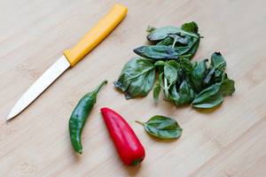 In the kitchen, green and red peppers and herbs