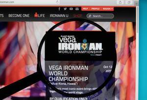 IRONMAN World Championship logo on a computer screen with a magnifying glass