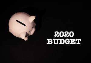 Jahreszahl 2020 mit Aufschrift "Budget", auf schwarzem Hintergrund, neben einem rosa Sparschwein