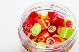 Jar of candy fruit candies close up