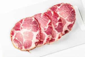 Jerky pork meat on a white kitchen board (Flip 2020)