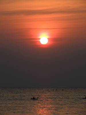 Kayaking on the beach in Goa on the backdrop of the setting sun
