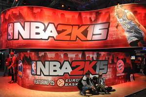 Kids sitting in front of basketball simulation game NBA 2k15