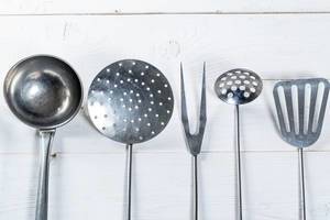 kitchen utensils on white wooden background