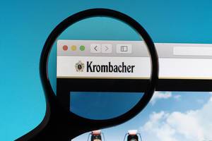 Krombacher logo under magnifying glass