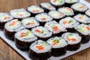 Large portion of Maki-rolls with salmon, avocado and cucumber