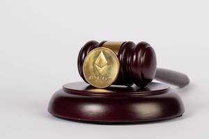 Law gavel and Ethereum coin on white background
