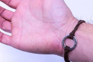Leather Bracelet with metal trinket and the writing "discipline"