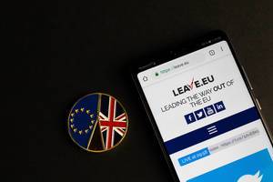 Leave.eu website on mobile phone with Brexit medal coin
