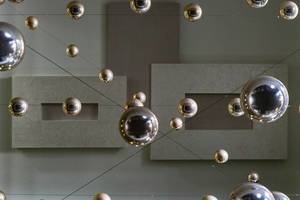 Low Angle Shot on Shiny Metal Balls Hanging From CEiling