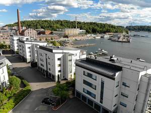 Luftbild zeigt Mehrfamilienhäuser am Hafen von Lahti, mit altem Hafengebäude im Hintergrund & Konzert-und Kongresshalle "Sibelius Talo" am Vesijärvisee