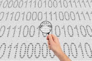 Magnifying glass and binary code