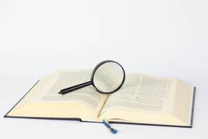 Magnifying glass on open book