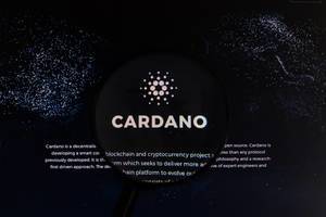 Magnifying glass over Cardano logo