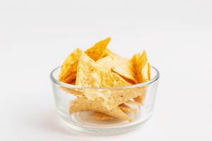 Mais-Chips vor weißem Hintergrund, Nahaufnahme