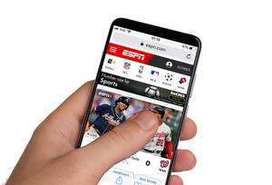 Male hands holding smartphone with an open ESPN website