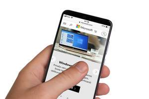 Male hands holding smartphone with an open Microsoft website