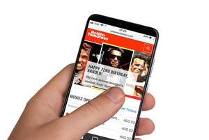 Male hands holding smartphone with an open Rotten Tomatoes website