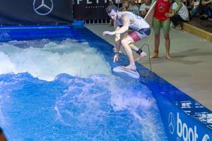 Man catching the permanent wave of the surf machine Citywave at fair Boot Düsseldorf 2018