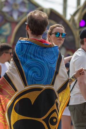 Man covered in a big cloth with the Tomorrowland logo on it
