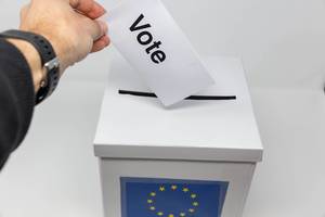 Man exercises his right to vote and holds a voting paper for the European elections