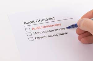 Man filling out Audit Checklist
