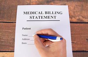 Man filling out medical billing statement
