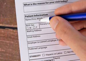Man filling out Patient information