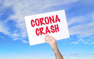 Man holding banner with Corona Crash text with blue sky background