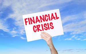 Man holding banner with Financial Crisis text with blue sky background