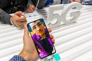 Man holds Samsung Galaxy A90 5G smartphone with Live mode in his hand