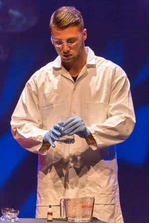 Man in a lab coat working with chemicals - TEDxVenlo 2017