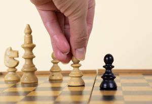 Man makes a move chess pawn