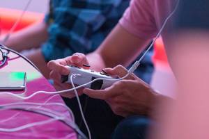 Man plays with a Stadia Controller at the Gamescom game fare in Cologne, Germany