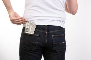 Man pulls the money from his jeans pocket