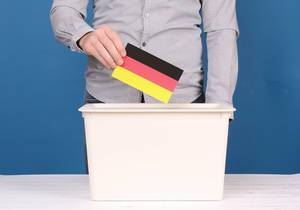 Man putting his vote in the ballot box in Germany.jpg
