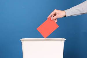 Man putting his vote in the ballot box