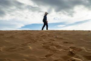 Man standing on Top of a Sand Dune in the Red Sand Dunes of Mui Ne, Vietnam  Flip 2019