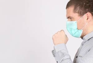 Man suffer from cough with face mask protection