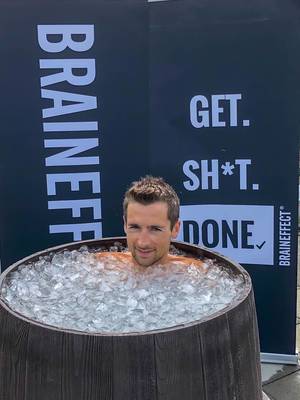 Man takes an cold ice bath, as a healthy regeneration procedure after sport and hard training