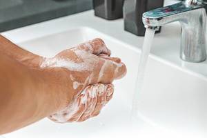 Man washing soapy hands in bathroom (Flip 2019)