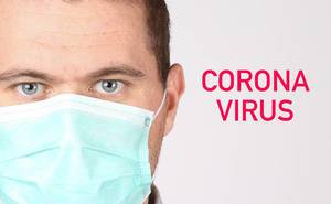 Man wearing face mask on white background with Coronavirus text