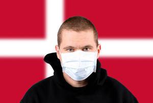 Man wearing protection face mask with flag of Denmark